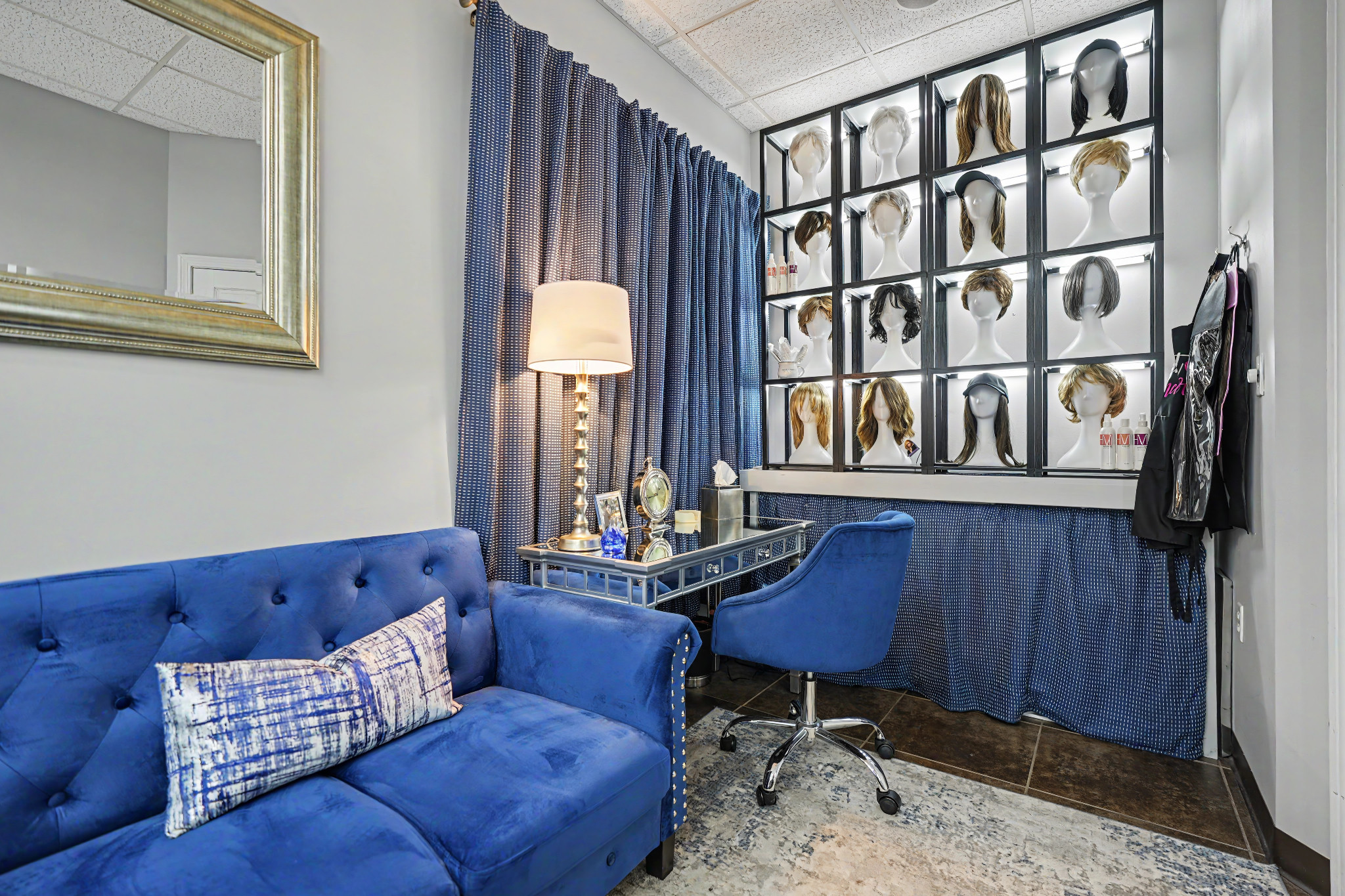 Blue seating and a quiet consultation area inside the Ovations Wig Studio